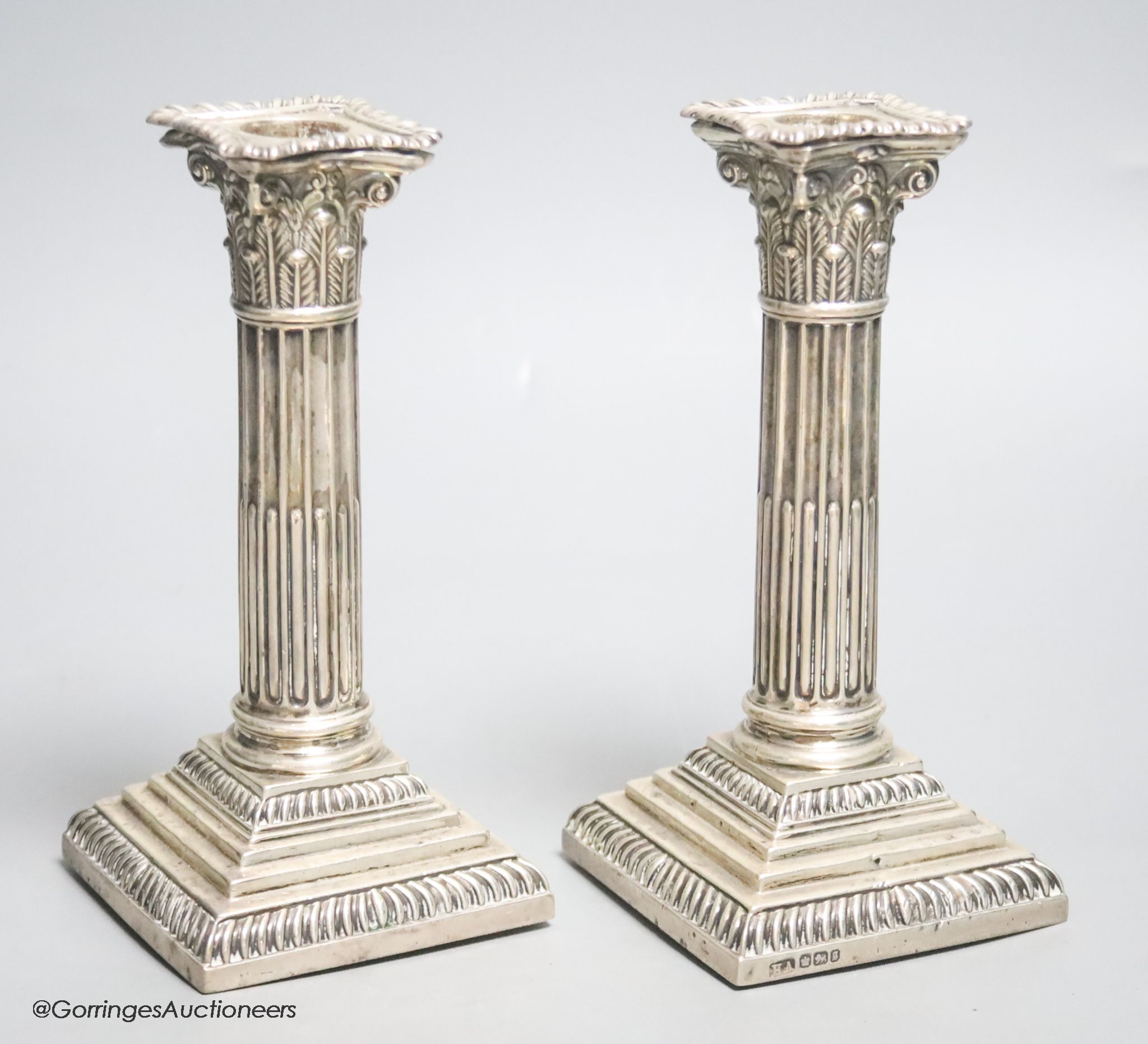 A pair of late Victorian silver Corinthian column dwarf candlesticks, Atkin Brothers, Sheffield, 1899, 17.6cm, weighted.
